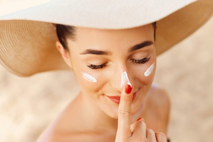 Woman applying SPF