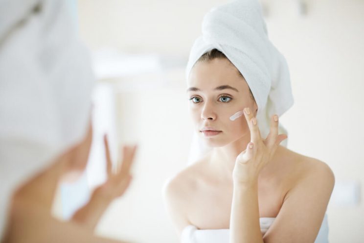 Woman applying face cream