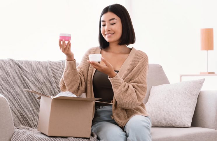 Woman opening box with skincare products