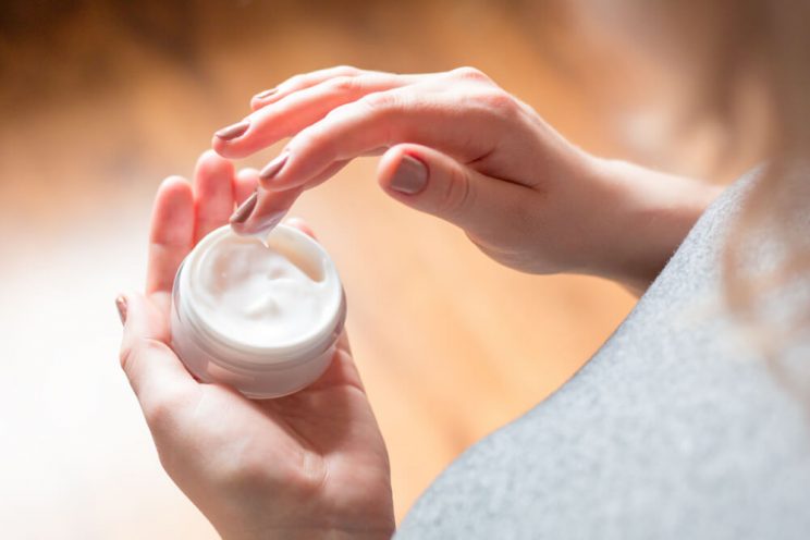 Woman using face cream