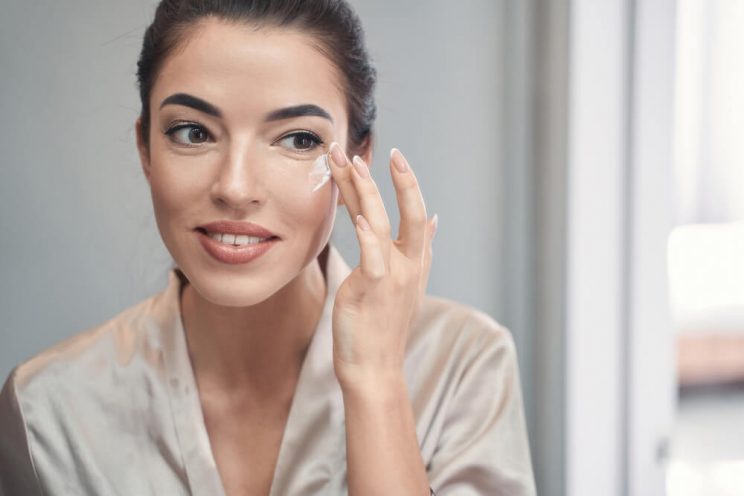 Woman applying eye cream