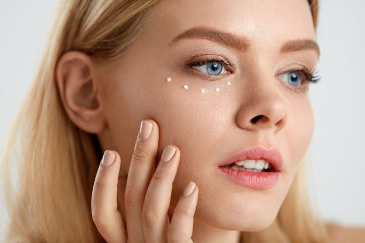 Woman using eye cream