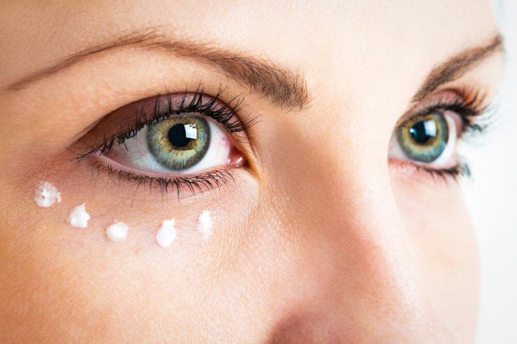 Woman using eye cream