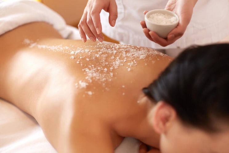 Woman with salt scrub on back