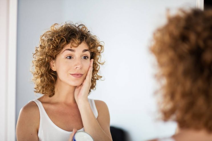 Woman applying face cream