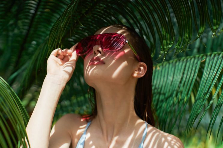 Woman protecting face from sun damage