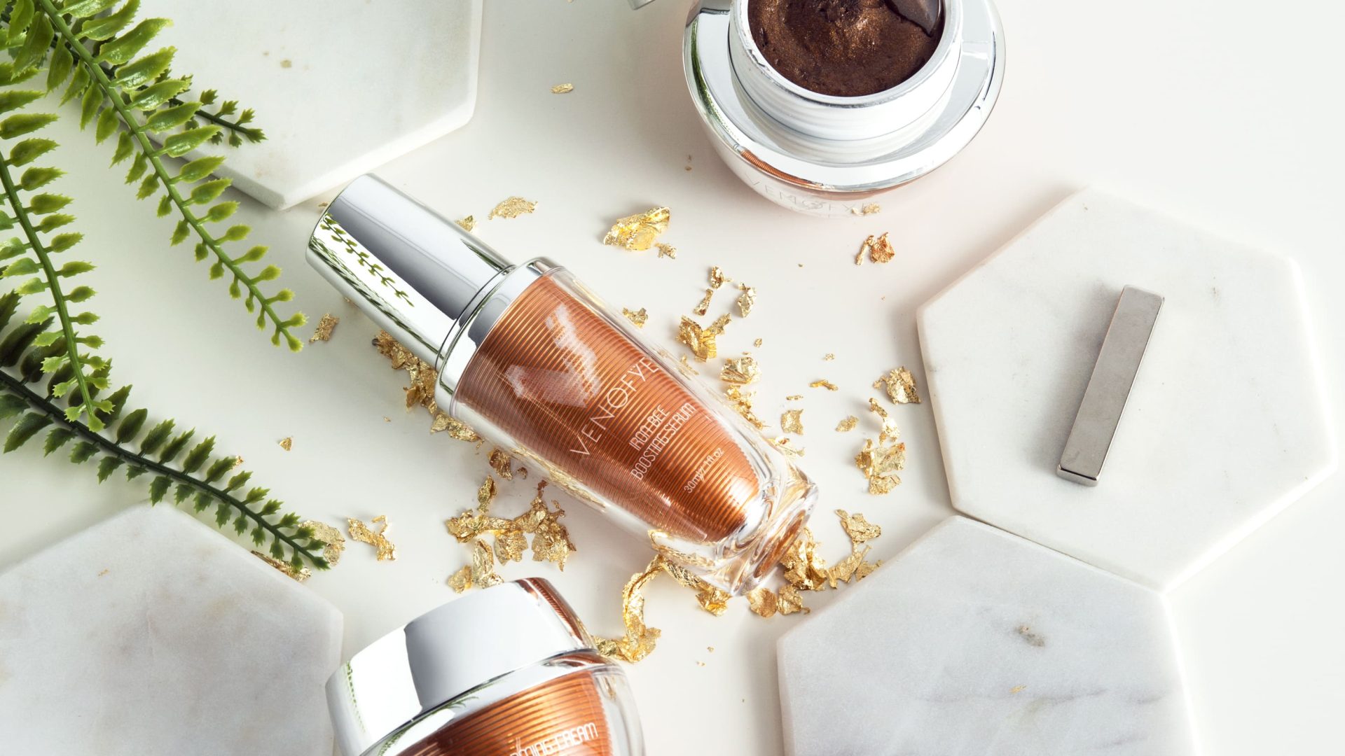 4 Venofye products on a white background with gold flakes and green plants