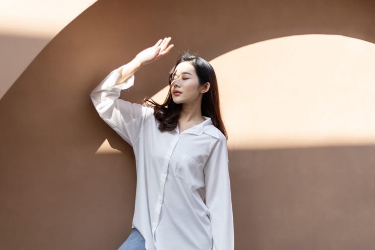 Woman blocking sun from face