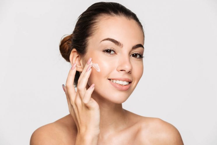 Woman applying face cream