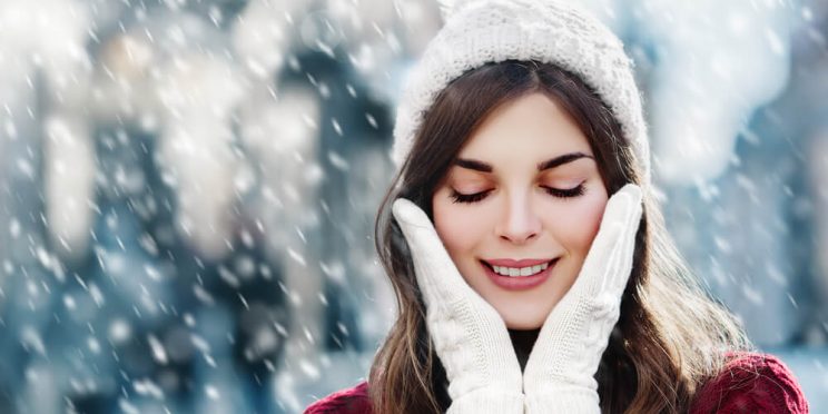 Woman in snow with winter skin problems
