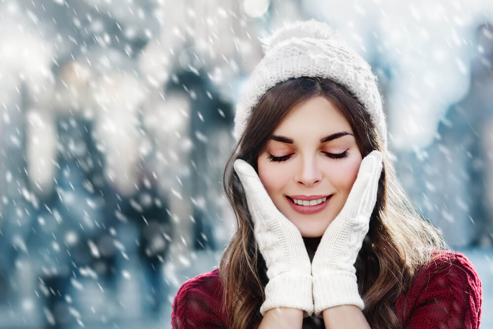 Woman in snow with winter skin problems