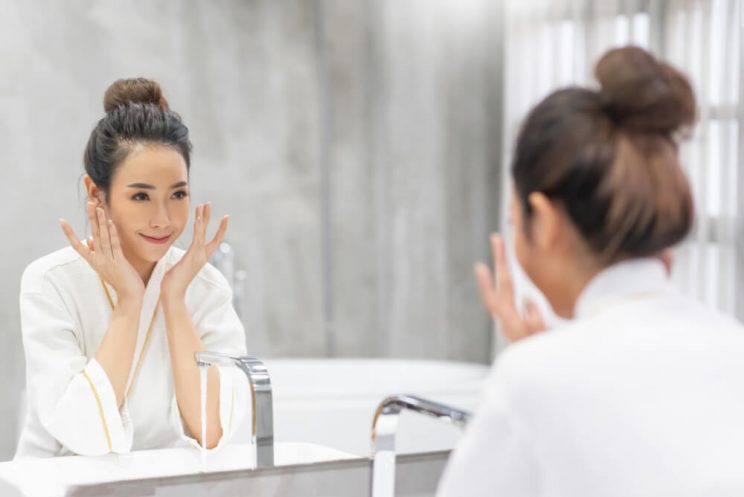 Woman applying face cream in winter skincare routine