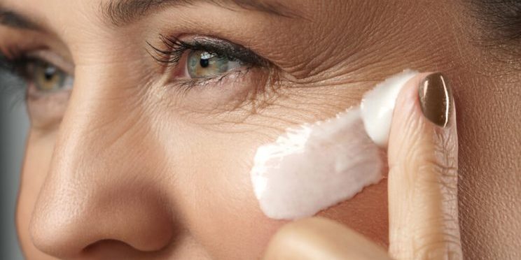 Woman using Royal Jelly Skin Care on eye area