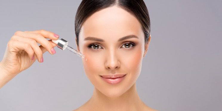 woman applying serum