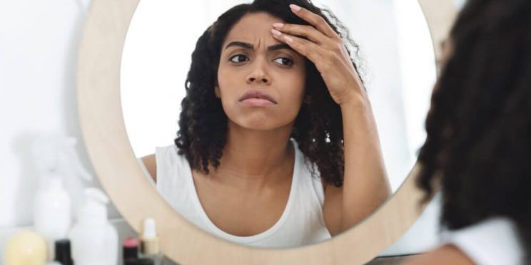 woman looking in mirror