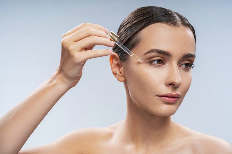 woman applying serum