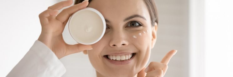woman holding cream smiling