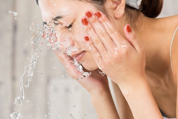 woman washing her face