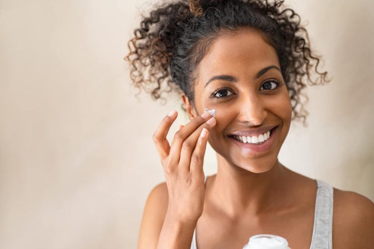 woman applying moisturizer